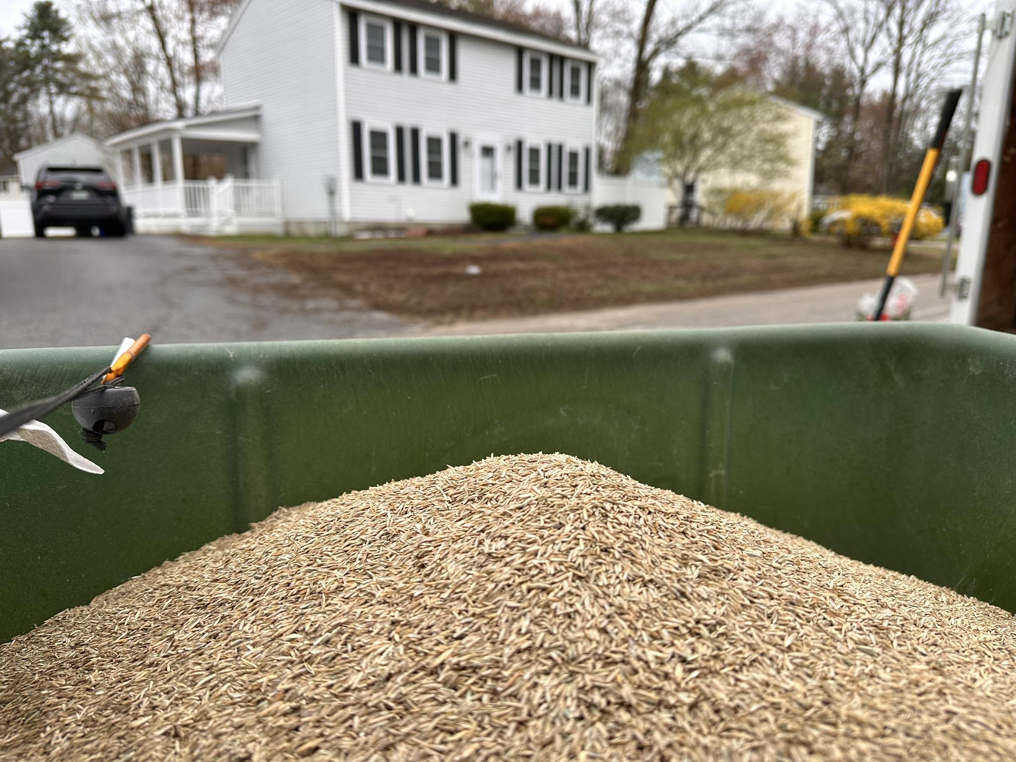 Kyle Poirier applying fertilizer to a residential lawn in Concord NH